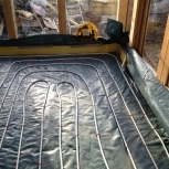 laying underfloor heating pipes